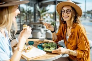 Two girls eating healthy food